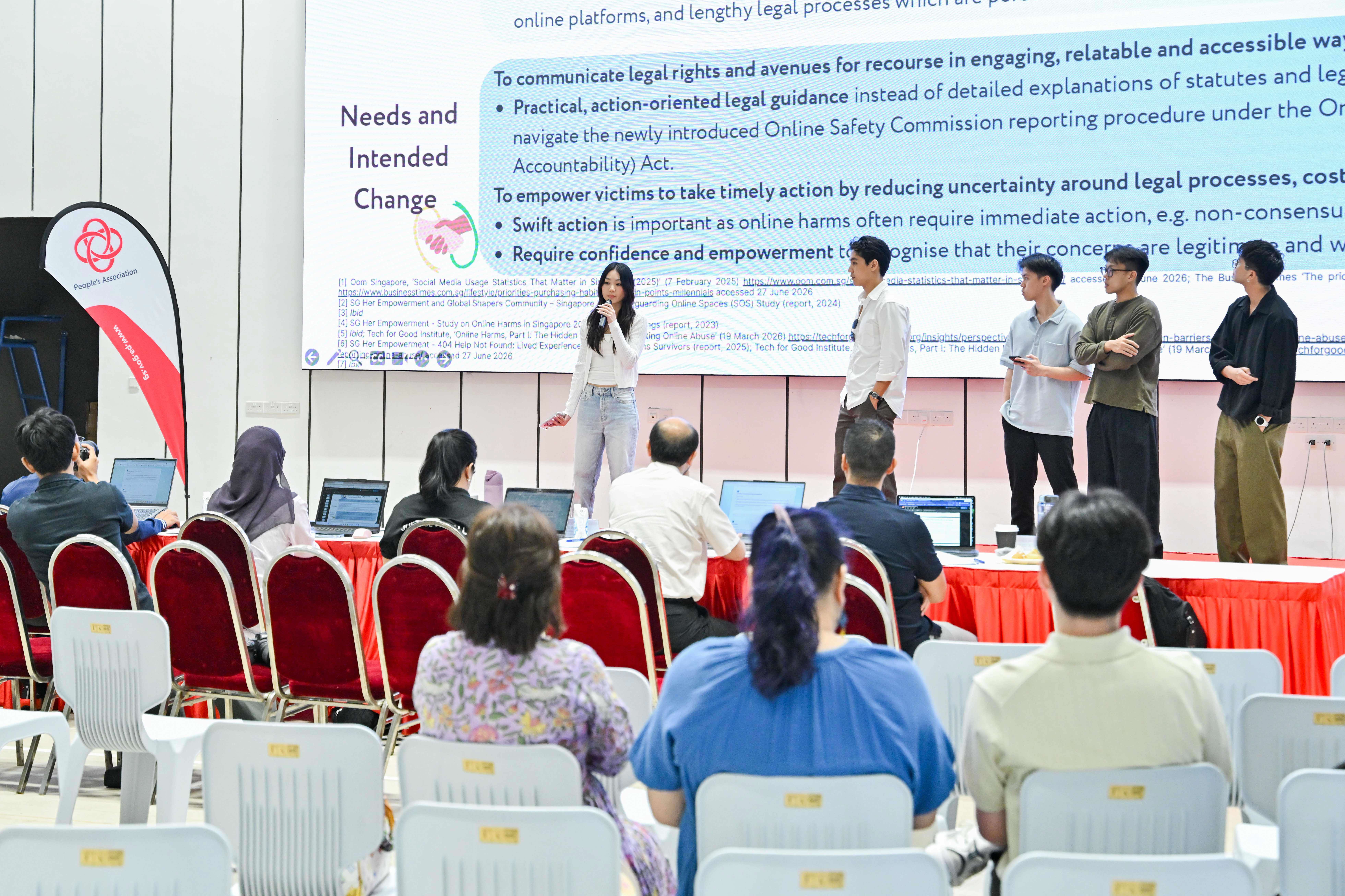Five students explaining to the audience and panel of judges